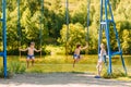 Children sit on a swing on the Playground in the Park Royalty Free Stock Photo