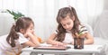 Children sit at the table and do their homework. The child learns at home. Home schooling Royalty Free Stock Photo