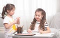 Children sit at the table and do their homework. The child learns at home. Home schooling. Royalty Free Stock Photo