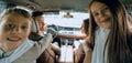 children sitting in the back seat of the car Royalty Free Stock Photo