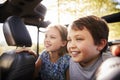 Children Sitting In Back Seat Of Open Top Car On Road Trip Royalty Free Stock Photo