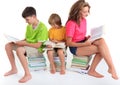 Children sitting on books