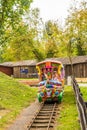 Children sitting in a colorful train attraction in the Zaurolandia dinosaur park, Rogowo, Poland