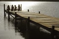 Children Sitting On Edge Of Jetty At Lake Royalty Free Stock Photo