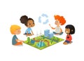 Children sitting on floor explore the model landscape, mountains, Eco-green city, plants, trees, solar panels and wind