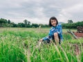 Children sitting in organic vegetables garden on sunny and sky background in rural or countryside Royalty Free Stock Photo