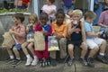 Children sitting at parade on curbside in central GA