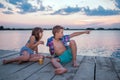 Children sitting by the river and having fun Royalty Free Stock Photo