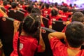 Children sitting on seats in the theater watching the performance