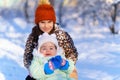 children sitting on sledge in the winter forest and playing  bright sunlight and shadows on the snow  beautiful nature Royalty Free Stock Photo