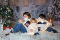 Children, sitting in the snow, wrapped in toilet paper and christmas light strings Royalty Free Stock Photo