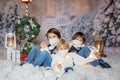 Children, sitting in the snow, wrapped in toilet paper and christmas light strings Royalty Free Stock Photo