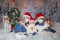 Children, sitting in the snow, wrapped in toilet paper and christmas light strings Royalty Free Stock Photo