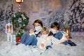 Children, sitting in the snow, wrapped in toilet paper and christmas light strings Royalty Free Stock Photo