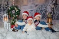 Children, sitting in the snow, wrapped in toilet paper and christmas light strings