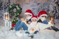 Children, sitting in the snow, wrapped in toilet paper and christmas light strings Royalty Free Stock Photo