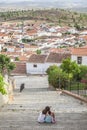 Children sitting on stairs of steep street in Hornachos, Spain