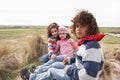 Children Sitting On Winter Beach Royalty Free Stock Photo