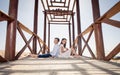 Children sitting on wooden structure on the beach Royalty Free Stock Photo