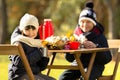 Children sitting at the wooden table on a picnic