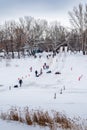 Children skating on an ice slide on the banks of the Ural River