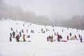 Children are skating at a toboggan run in winter