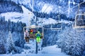 Children on the ski lift over magic winter forest Royalty Free Stock Photo