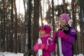 Children skiing in the forest winter snow kids walk in the Park