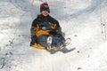 Children sledding down the hill at winter time, Park Maksimir in Zagreb Royalty Free Stock Photo