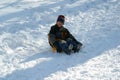 Children sledding down the hill at winter time, Park Maksimir in Zagreb Royalty Free Stock Photo