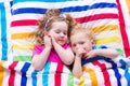 Children sleeping under colorful blanket Royalty Free Stock Photo