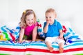 Children sleeping under colorful blanket Royalty Free Stock Photo