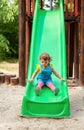 Children on slide - girl chuting down slide at playground Royalty Free Stock Photo