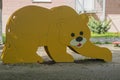 Children slide for rolling down top with wooden sides in form of bear painted in yellow. Royalty Free Stock Photo