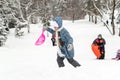 Children Sliding on Snow Slides in Russian Winter