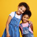 Children, smile portrait and happy sisters in studio with love, care and support of family on yellow background. Cute Royalty Free Stock Photo