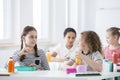 Children during snack time in their classroom. Bottles of fruit