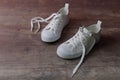 Children sneakers on textured wood floor