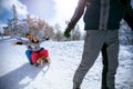 Children on snow sledding and enjoying on sunny winter day Royalty Free Stock Photo