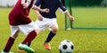 Children soccer game. Kids kicking soccer ball on a sports grass field Royalty Free Stock Photo