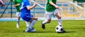 Children Soccer Players Running with the Ball. Kids in Blue and Green Shirts