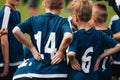 Children in soccer team. Young boys standing in a team with coach