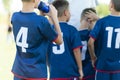 Children in soccer team. Young boys standing in a team with coach