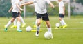 Children on Soccer Training. Group of Young Boys Kicking Football Balls on Grass Field Royalty Free Stock Photo