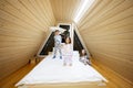 Children in soft warm pajamas playing at wooden cabin home. Concept of childhood, leisure activity, happiness. Brother and sisters Royalty Free Stock Photo