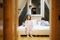 Children in soft warm pajamas playing at wooden cabin home. Concept of childhood, leisure activity, happiness. Brother and sisters Royalty Free Stock Photo