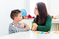 Children speech therapy concept. Preschooler practicing correct pronunciation with a female speech therapist. Royalty Free Stock Photo