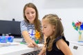 Children speech therapy concept. Preschooler practicing correct pronunciation with a female speech therapist. Royalty Free Stock Photo