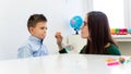 Children speech therapy concept. Preschooler practicing correct pronunciation with a female speech therapist. Royalty Free Stock Photo