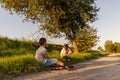 Children spend their free time inline skating on a path surrounded by greenery, sharing laughter and friendship under the warm Royalty Free Stock Photo